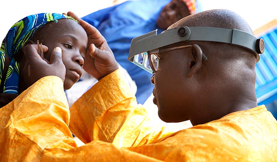 Dr. Kadri performs an eye exam on a young girl.