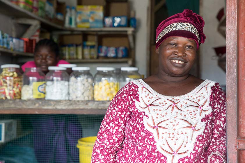 A woman stands in the doorway of her store in Monrovia, Liberia.