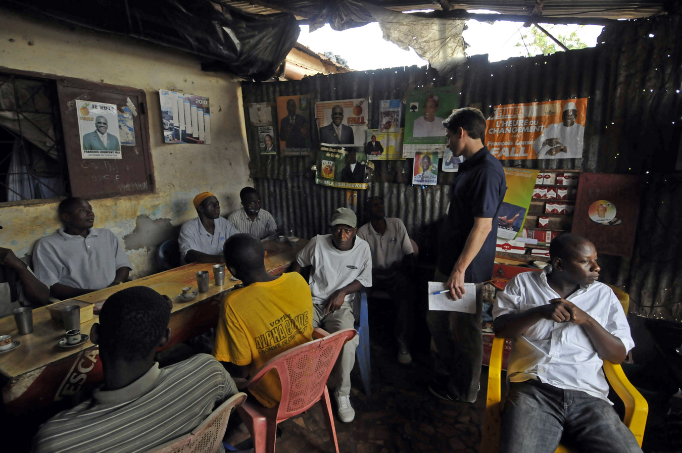 Carter Center observer talks with men at a restaurant about Sunday's elections.