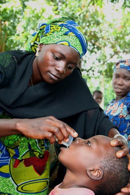 David Nuhu's mother administers medication.