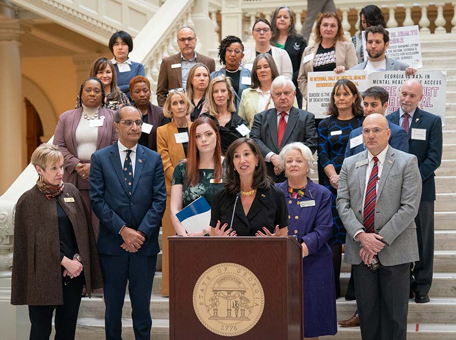 Paige Alexander speaks on the capitol stairs.