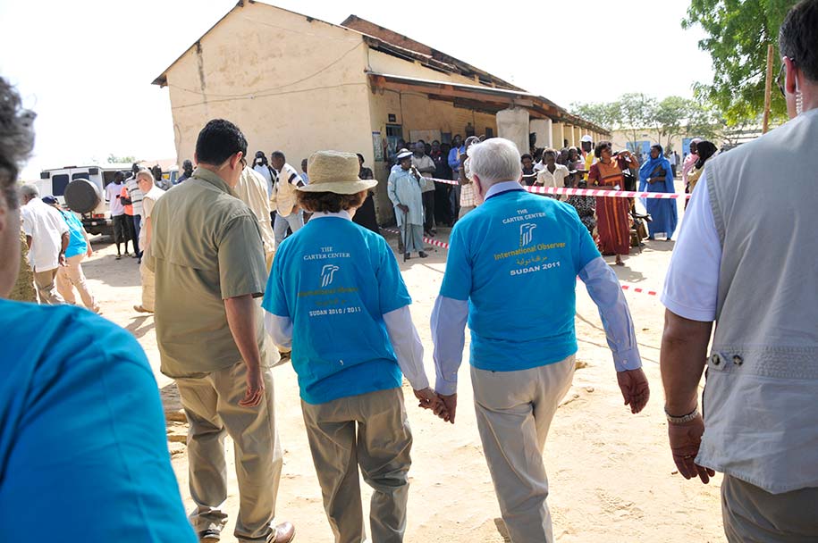 President and Mrs. Carter leave a polling center near Juba.