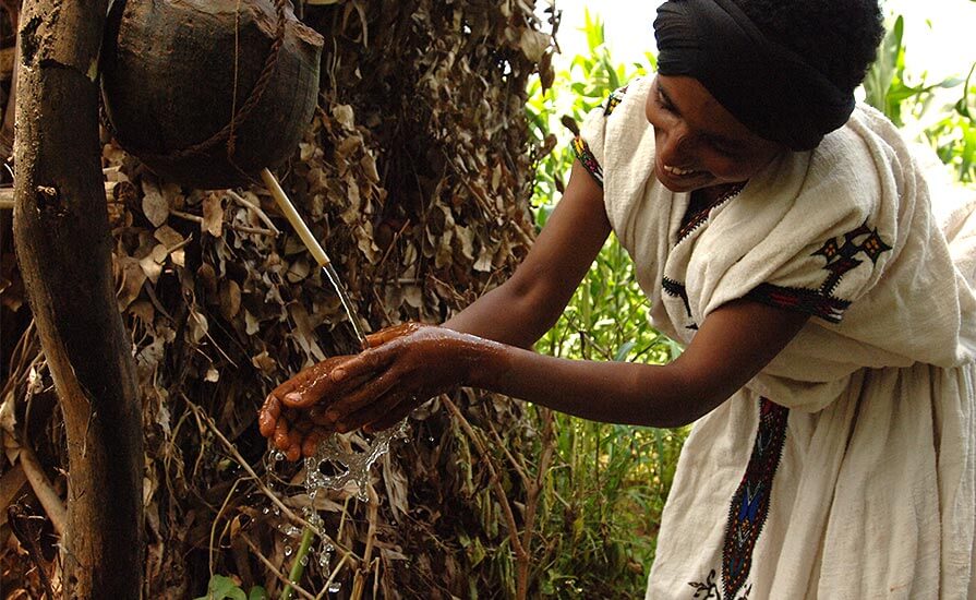 An Ethiopian woman washes her hands. Hand and face washing are part of the SAFE strategy for controlling trachoma.