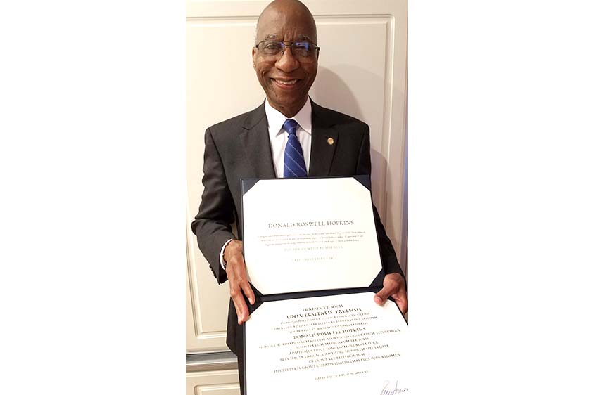 Photo of Dr. Hopkins holding his honorary Yale degree.